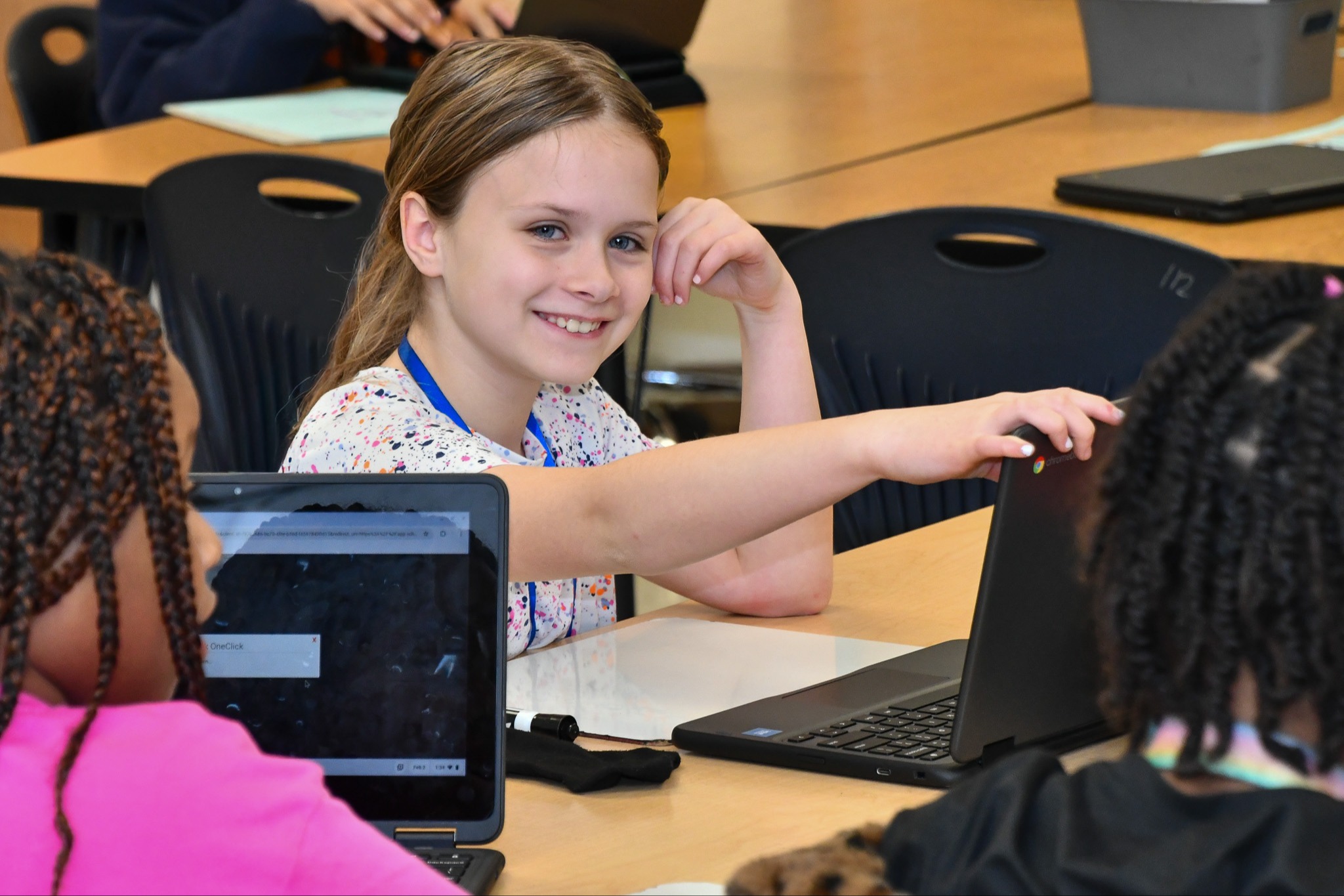 Student smiling while working on an activity