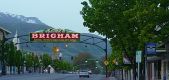 The Brigham City arch with leafy trees along Main Street