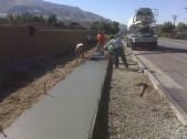 work crews pour a concrete sidewalk