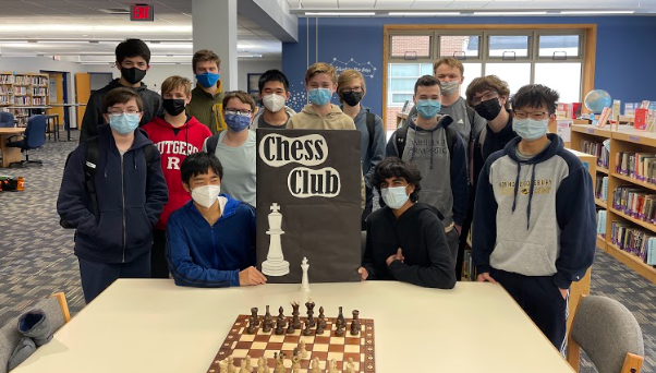 Chess Club students behind a chess board