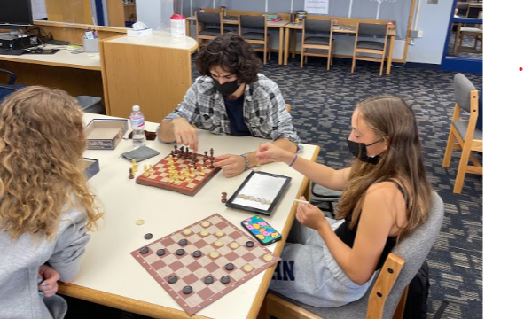 Students behind playing chess and checkers