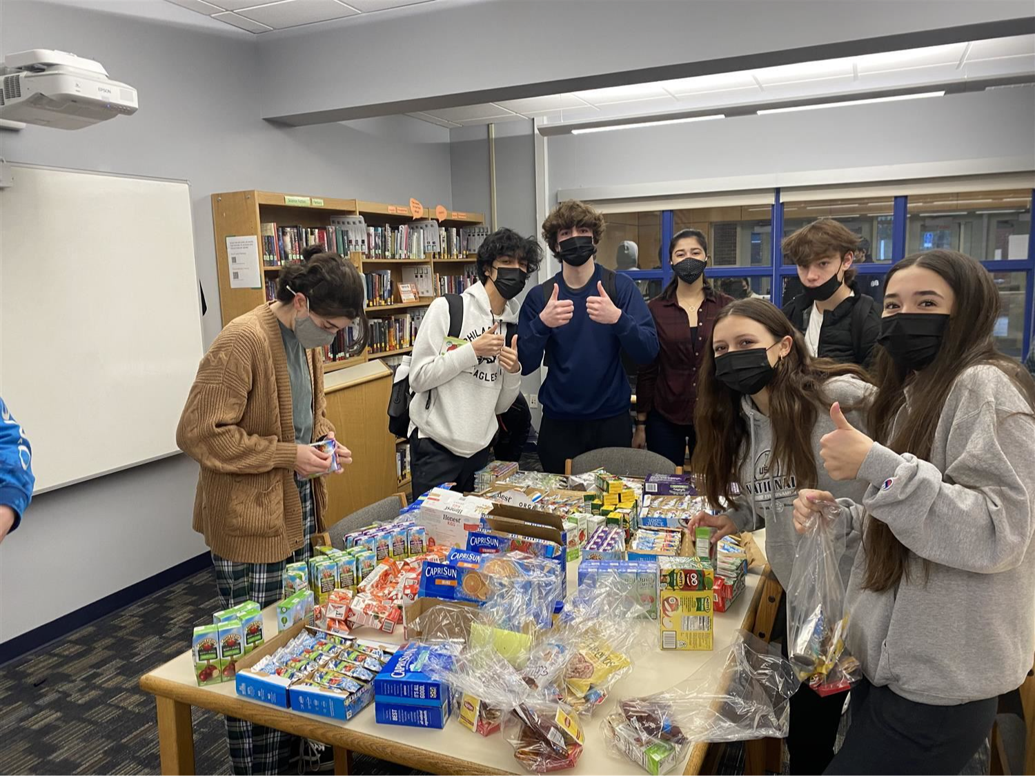 Key Club students working on a project to pack food 