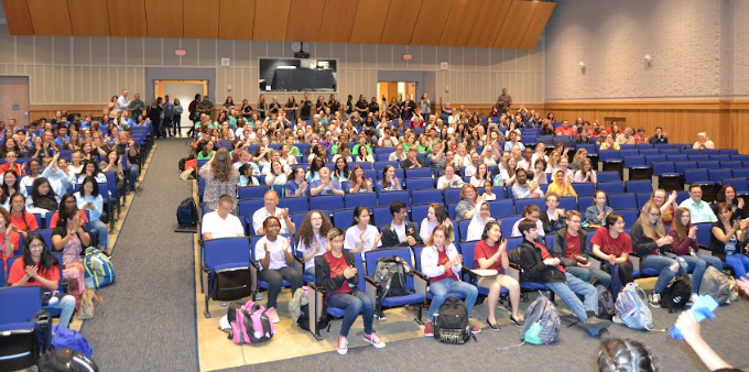 Reading Olympic students in auditorium