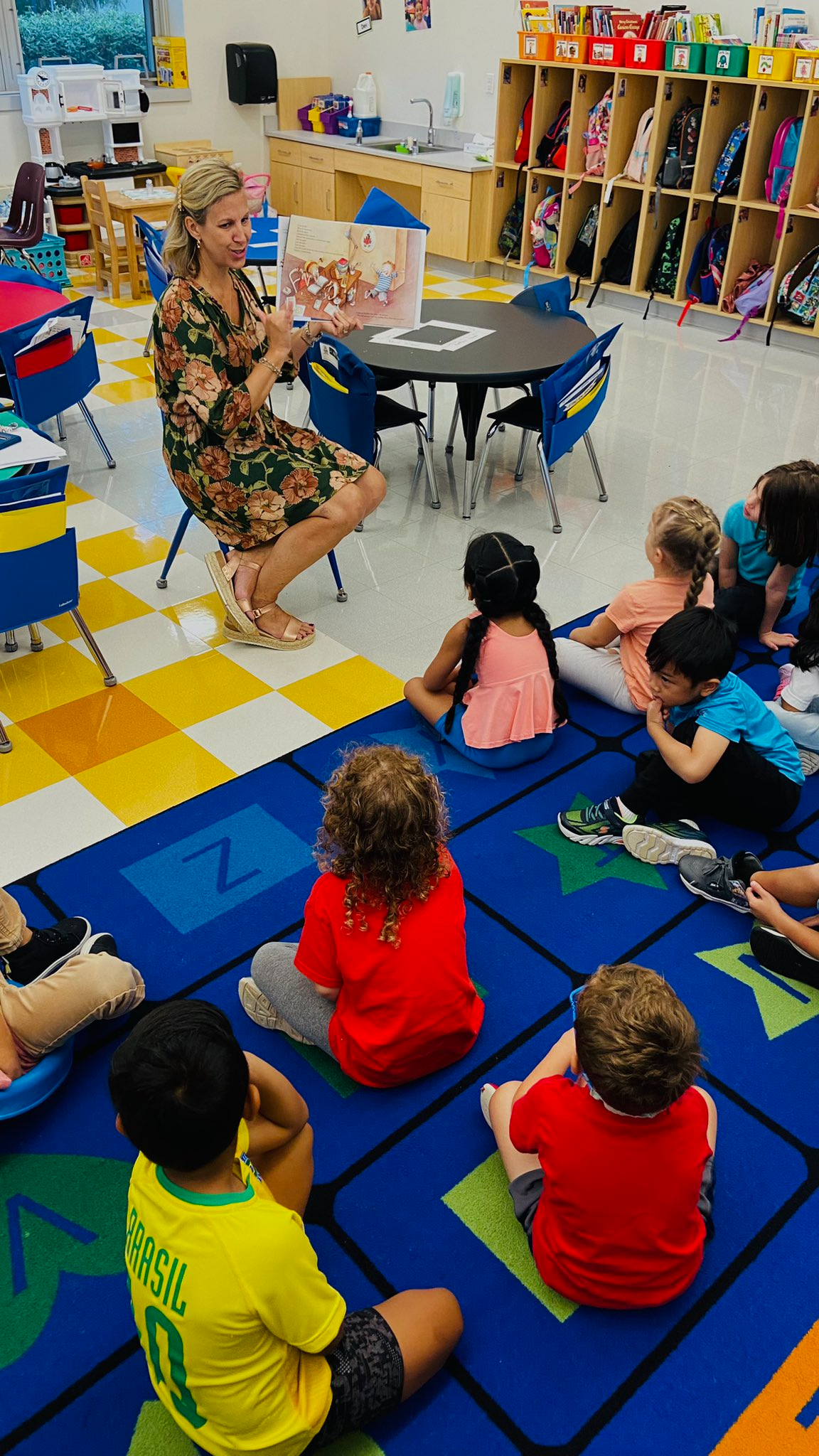 Principal leading an activity with students.