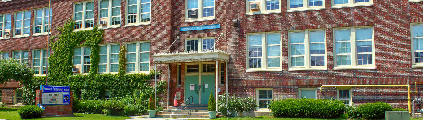 Burncoat Prep: A large brick building with ivy growing on the facade