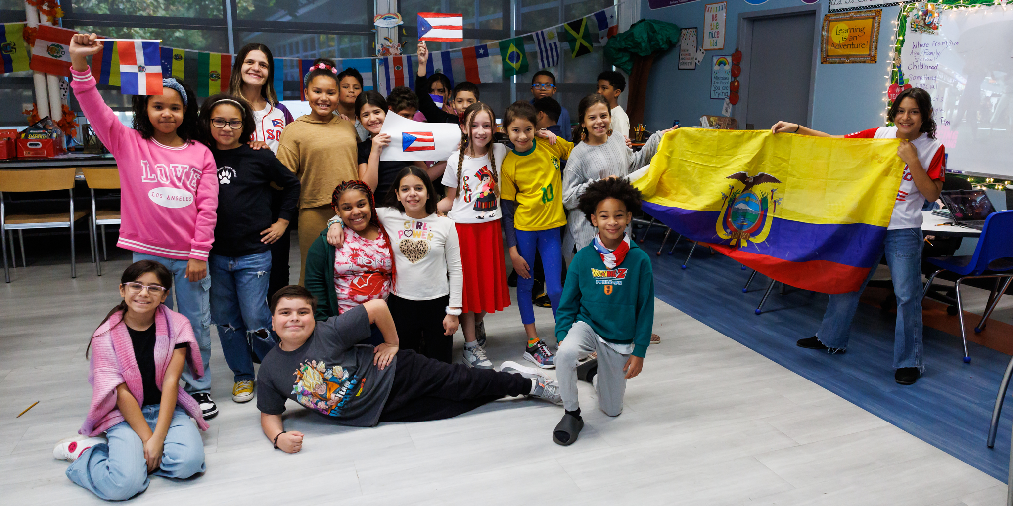 A classroom of students take a group photo.