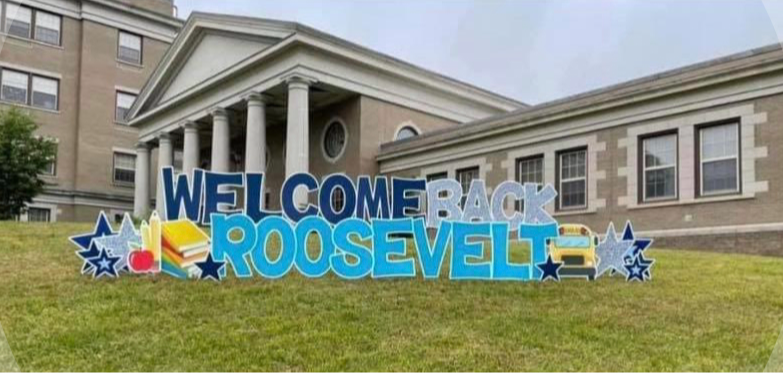 Rooselvelt Elementary tan brick building with columns at the entrance