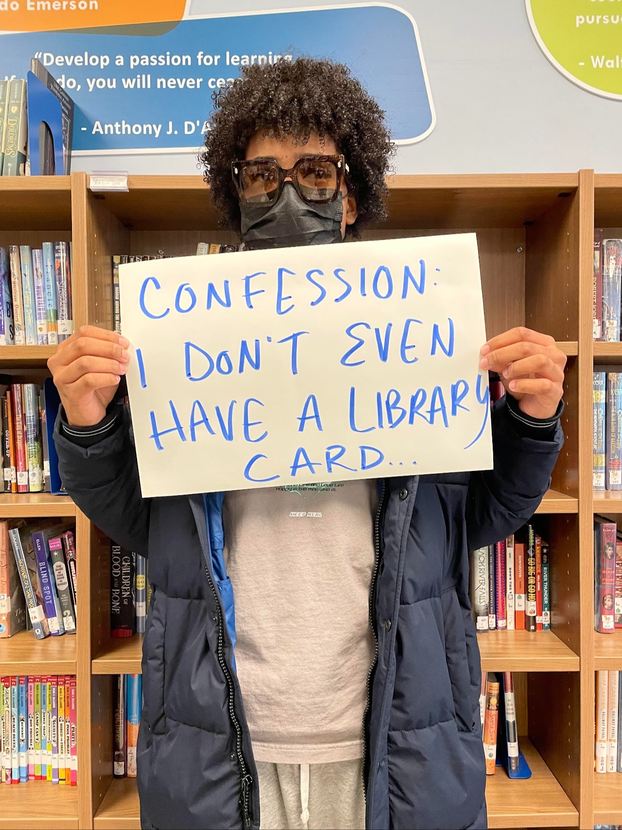 Photo of a student holding a sign that says, "Confession: I don't even have a library card."