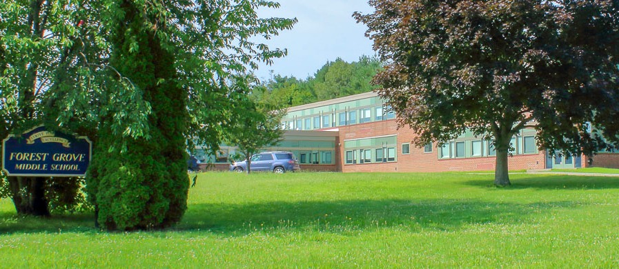 Forest Grove Middle School exterior with large trees covering our view 