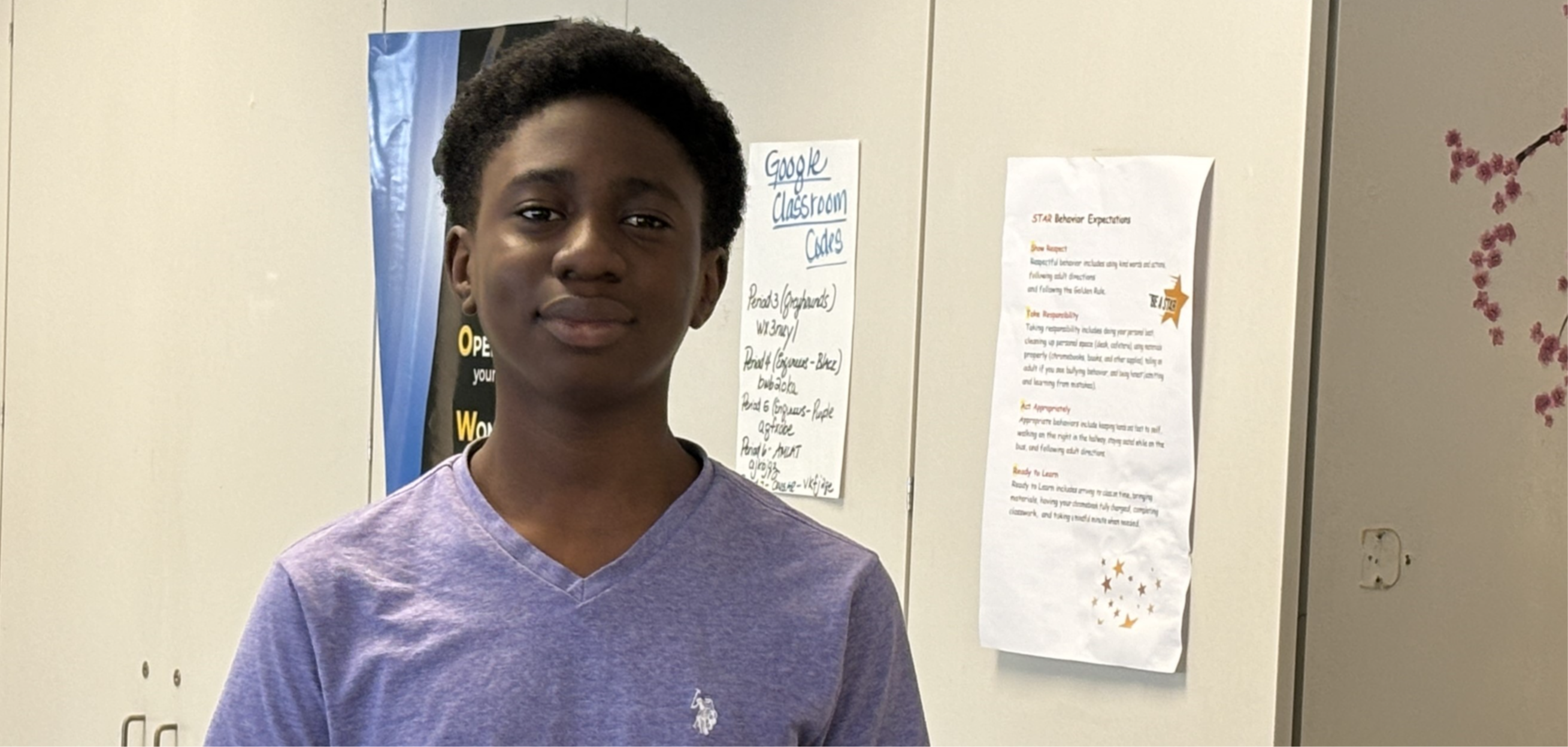 A Forest Grove Middle School student proudly showcasing their project to classmates and staff.