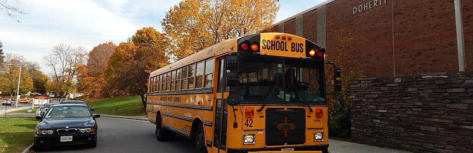 school bus parked in front of the school building