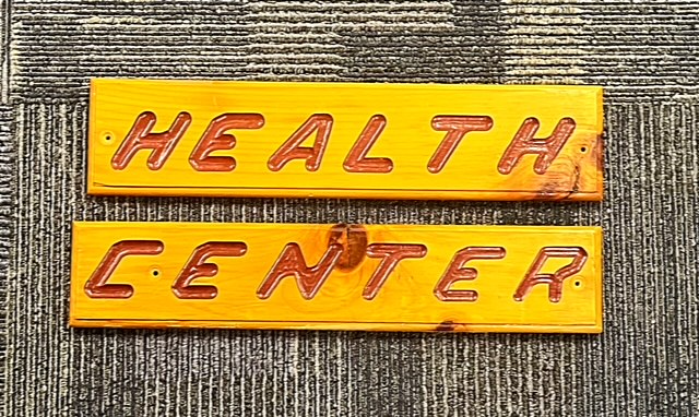 2-piece wooden sign that says Health Center