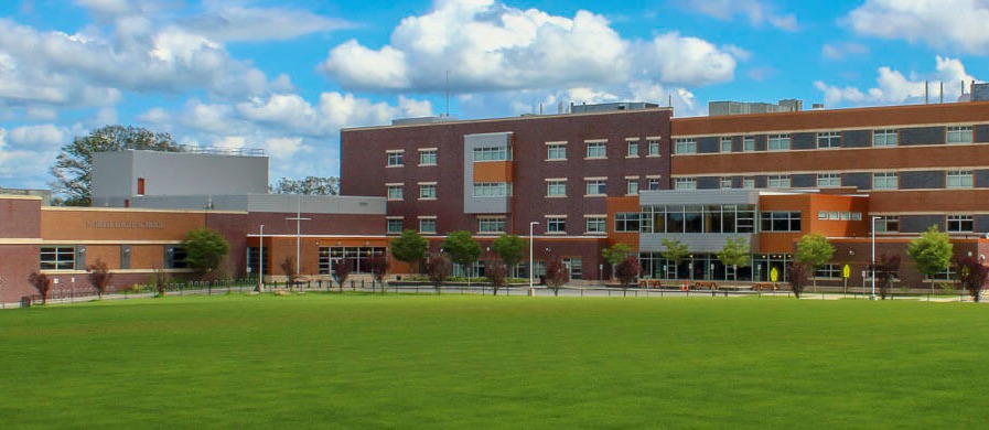 North High School large campus of big red and orange buildings around a green lawn