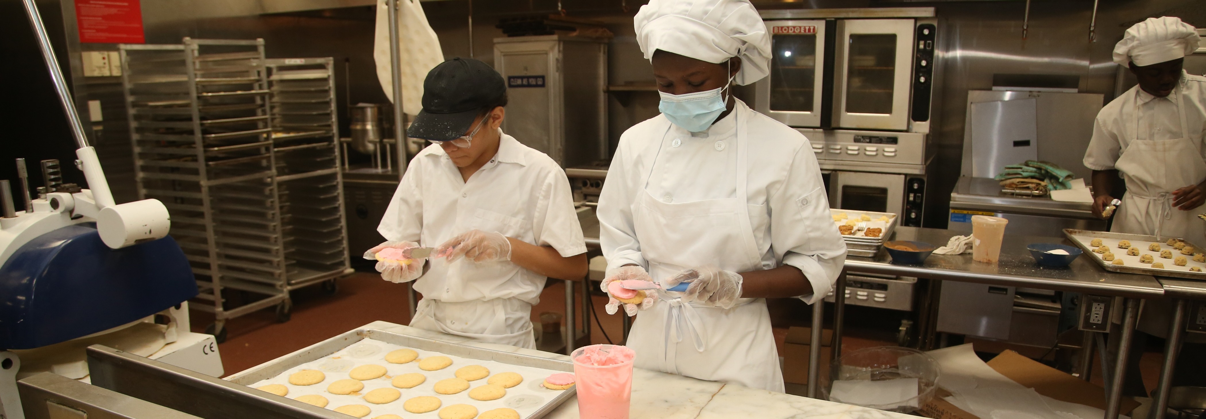 Two students working in an industrial kitchen