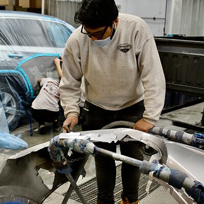 Student working at the shop on the Automotive Collision class