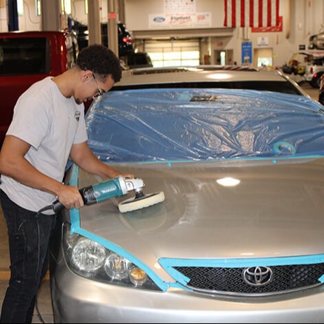 Student working at the shop on the Automotive Collision class
