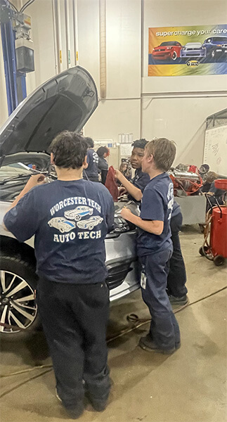 Students working on customer and training vehicles in Automotive Technology program