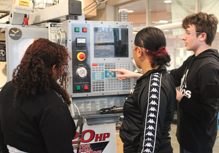Students in front of a milling machine