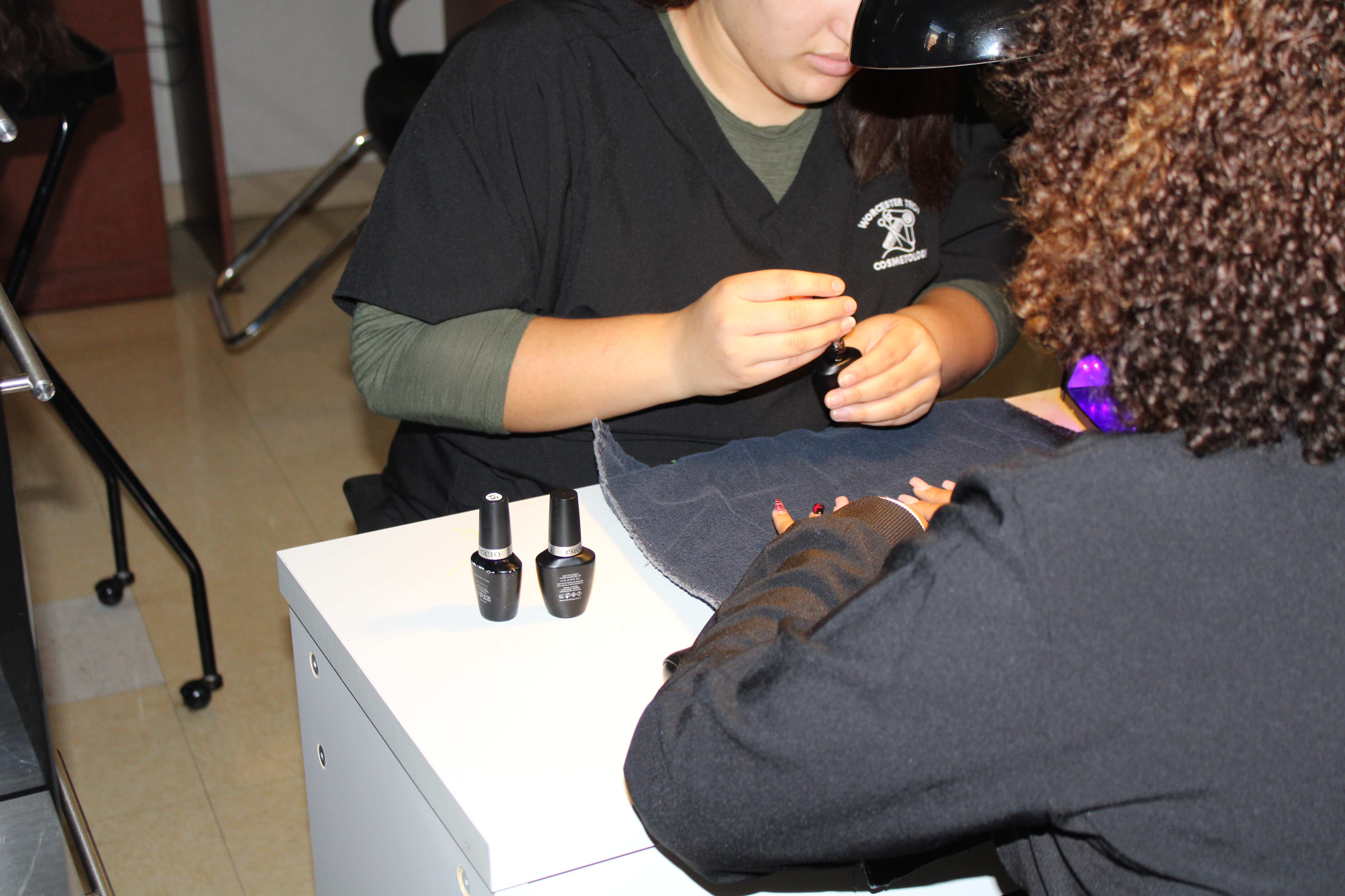 Painting the nail of someone in the salon.