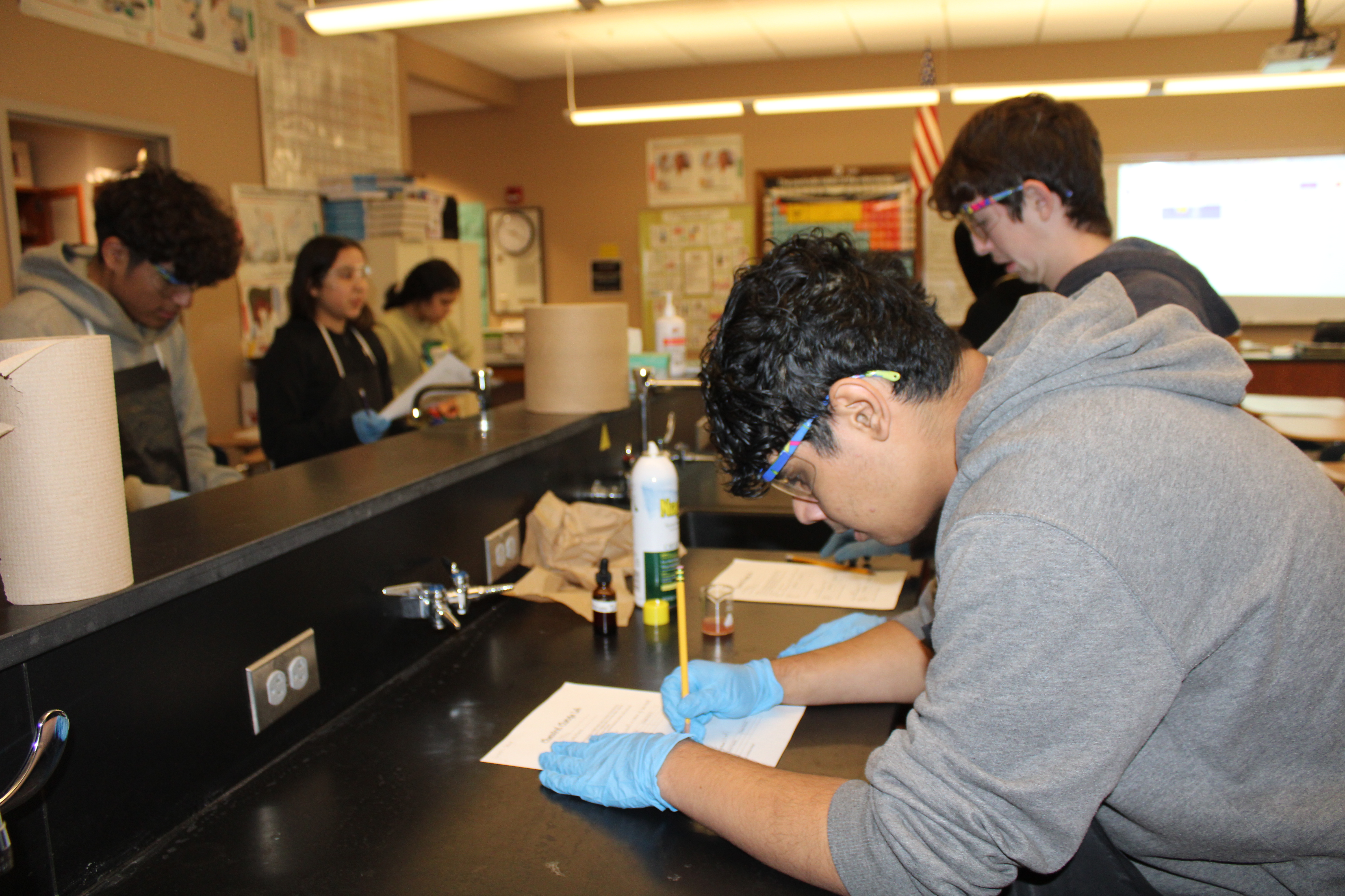 Student recording data during lab experiment.