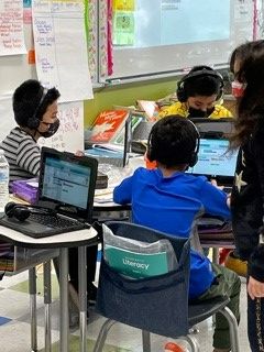 Group of kids at class using laptops