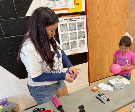 Student teaching the science behind fingerprinting