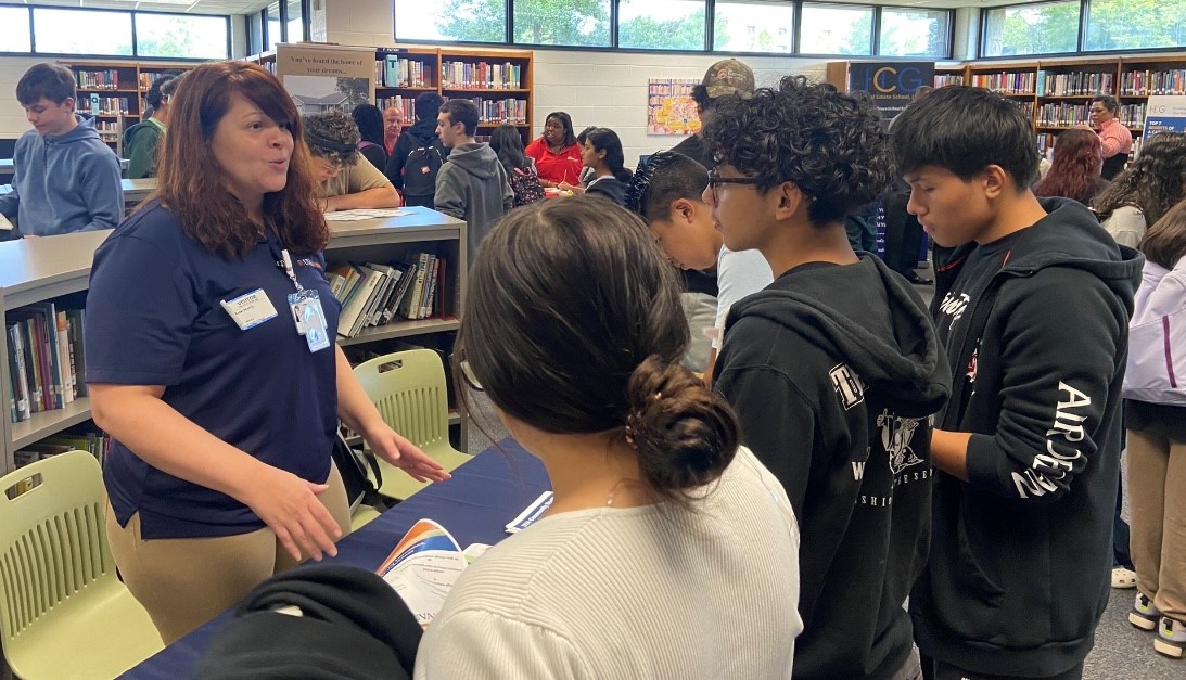 Middle school students talking to businesses about possible career paths.