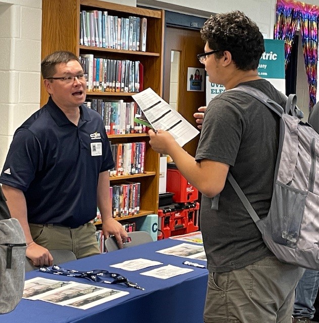 Student talking to company