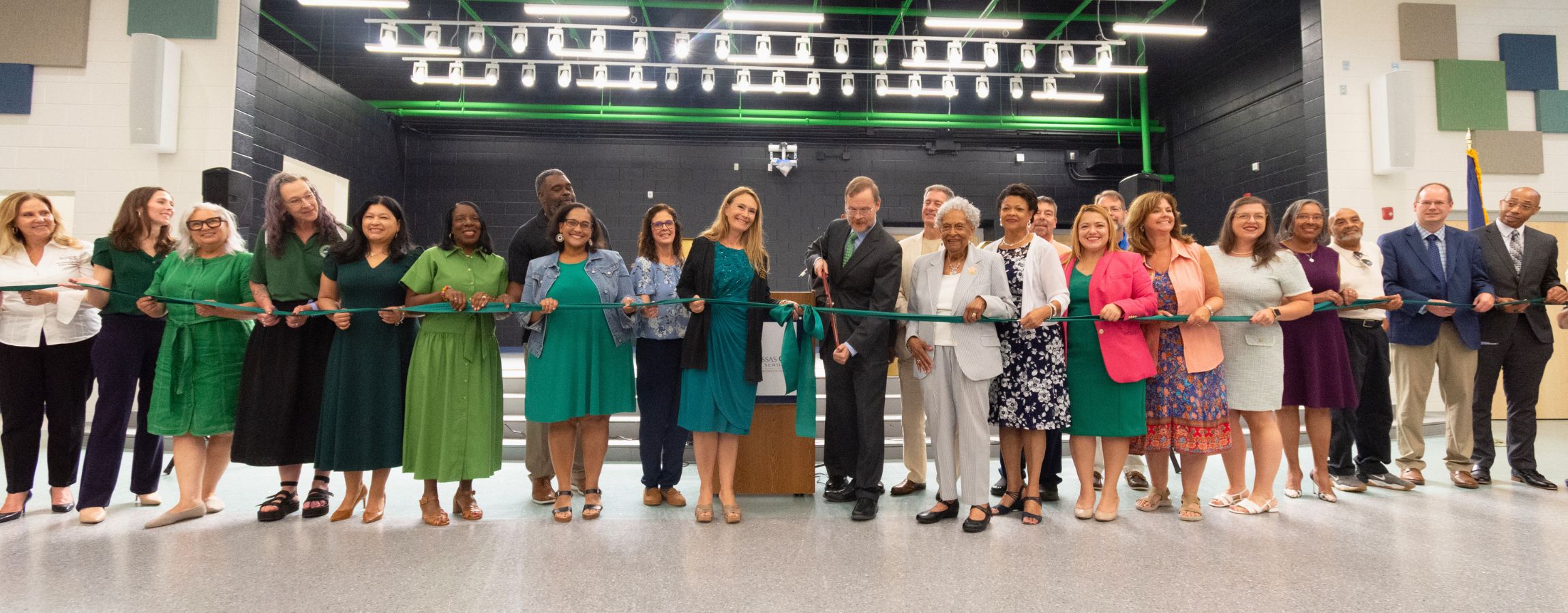 Group of people holding a green ribbon