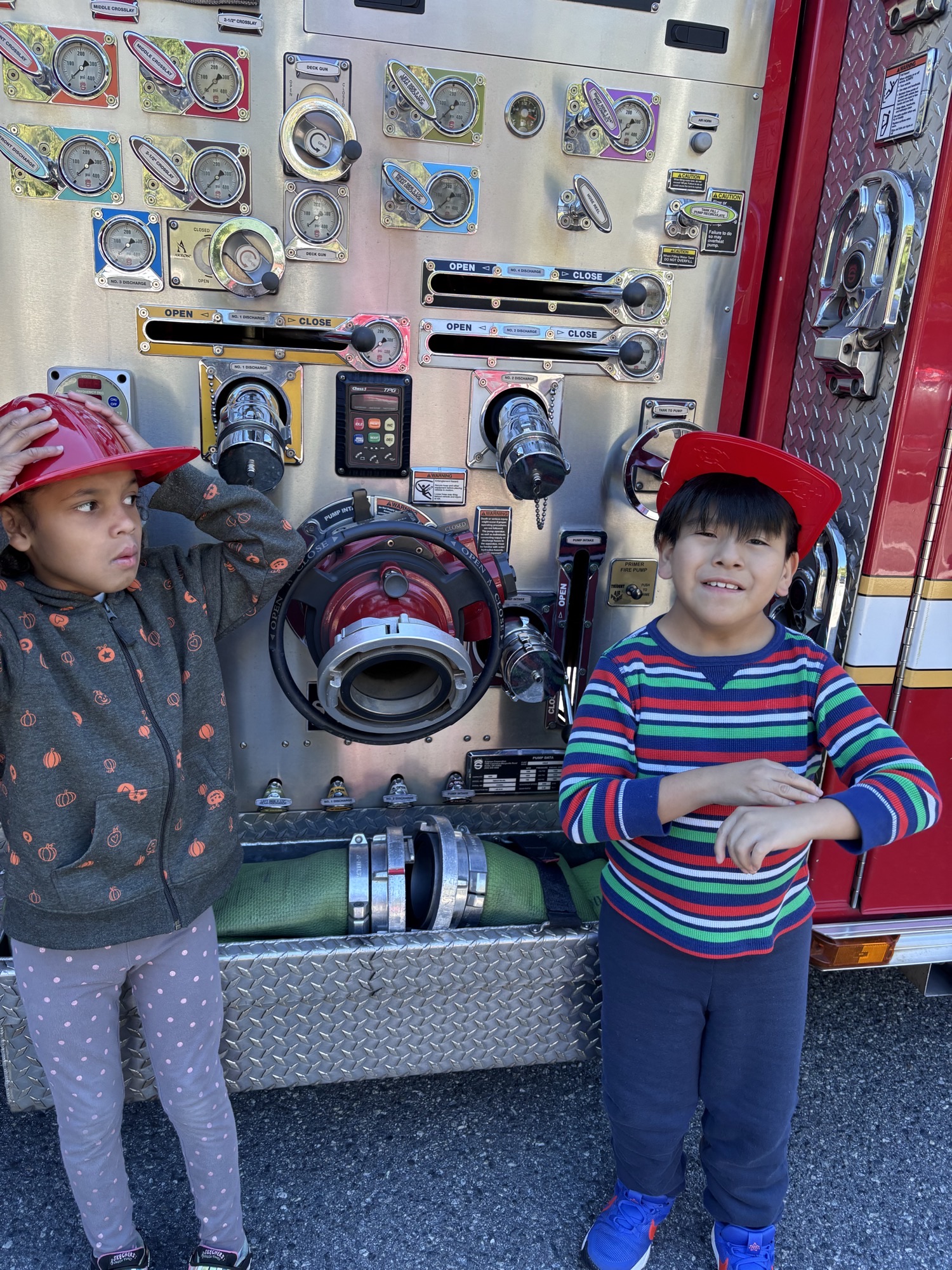 students with firefighter at firetruck