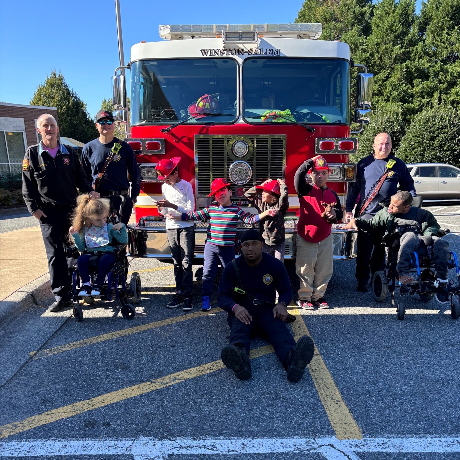 class posing in front of  fire truck