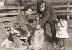 An old photo of some people with a turkey.