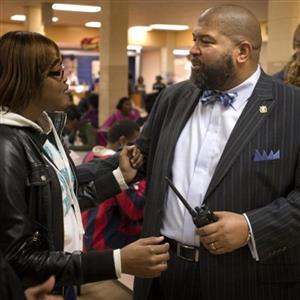 Ronald Travis with student at Carver High School 