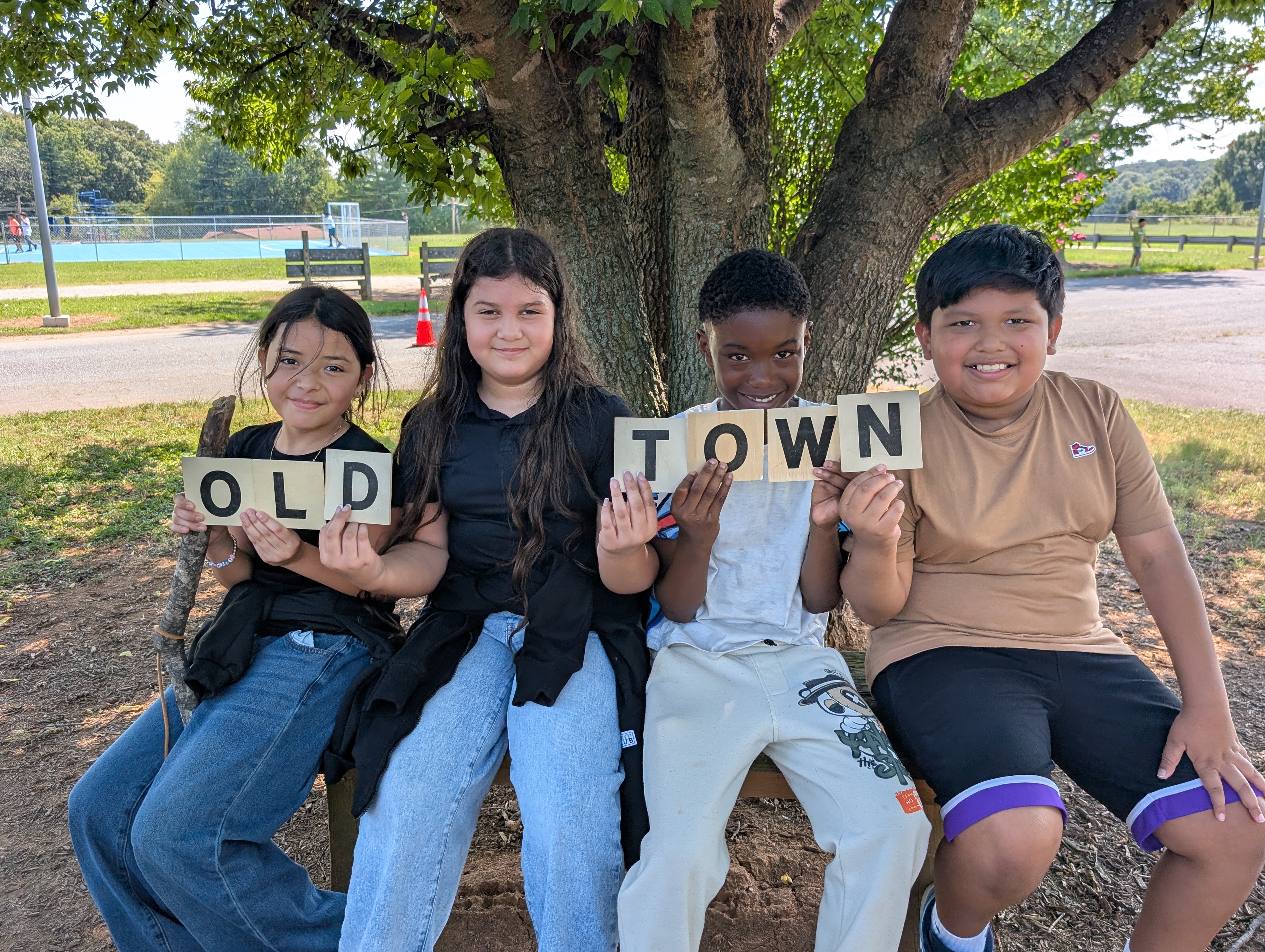5th Graders holding up letters that spell "OLD TOWN"