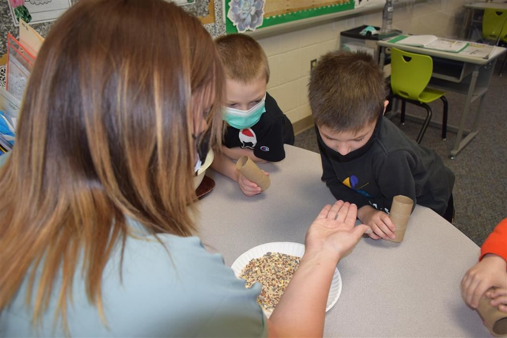 Students work with their teacher on a project