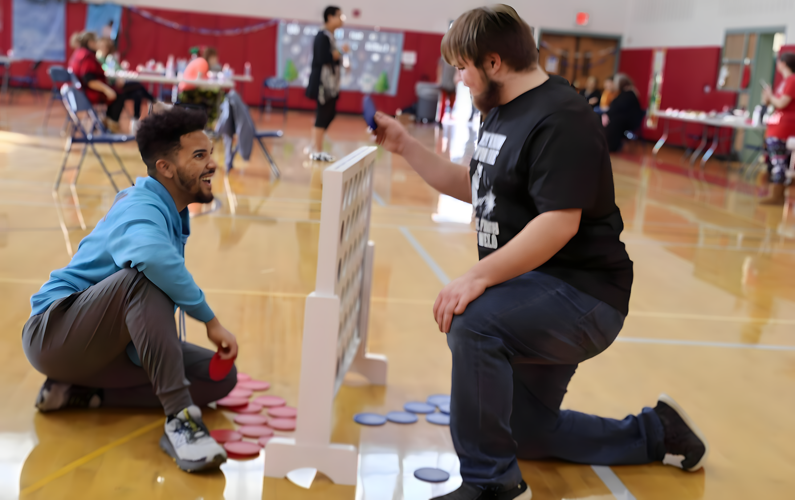 A staff member works with a student