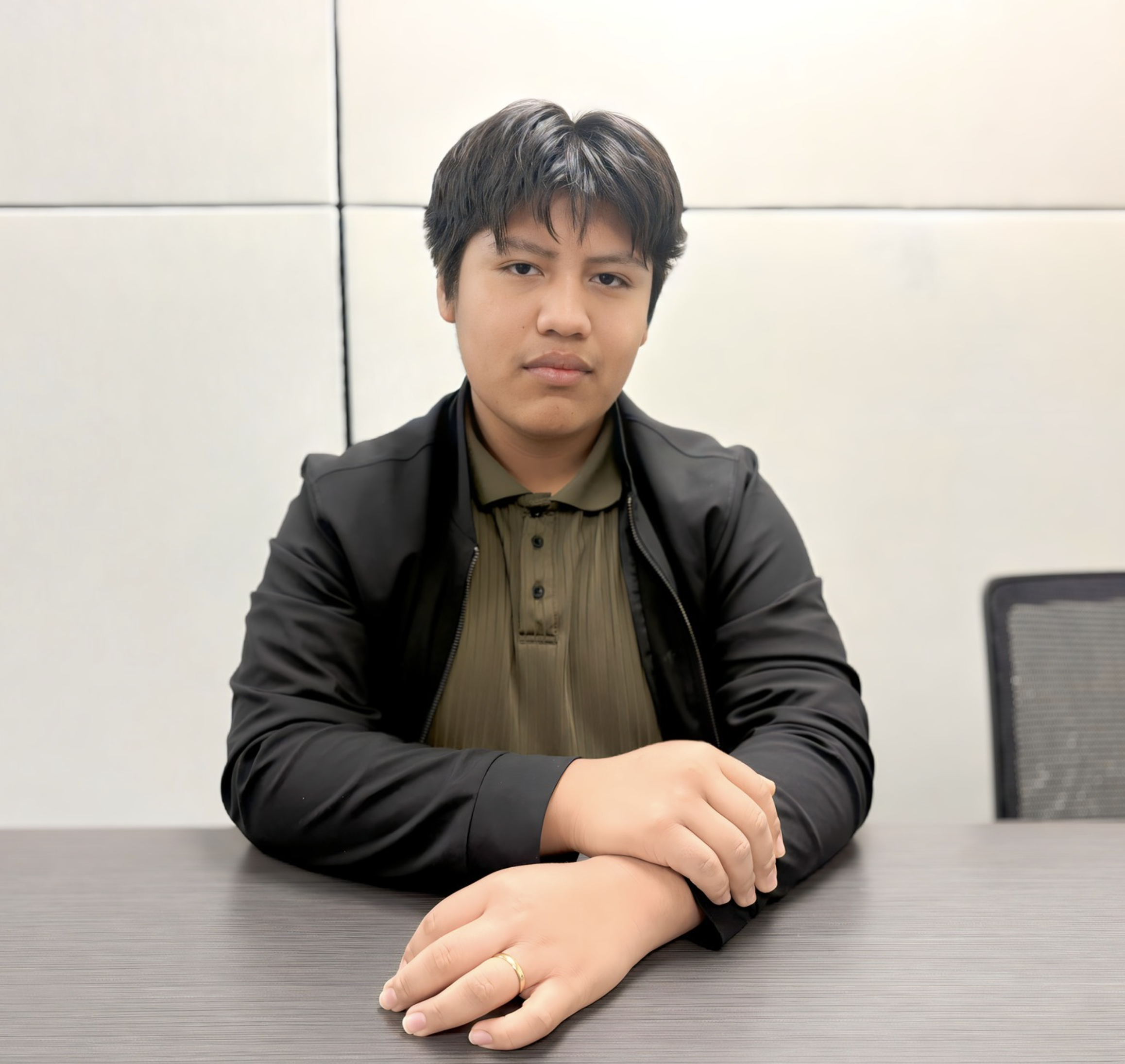 Angel sitting in the office posing for a photo.