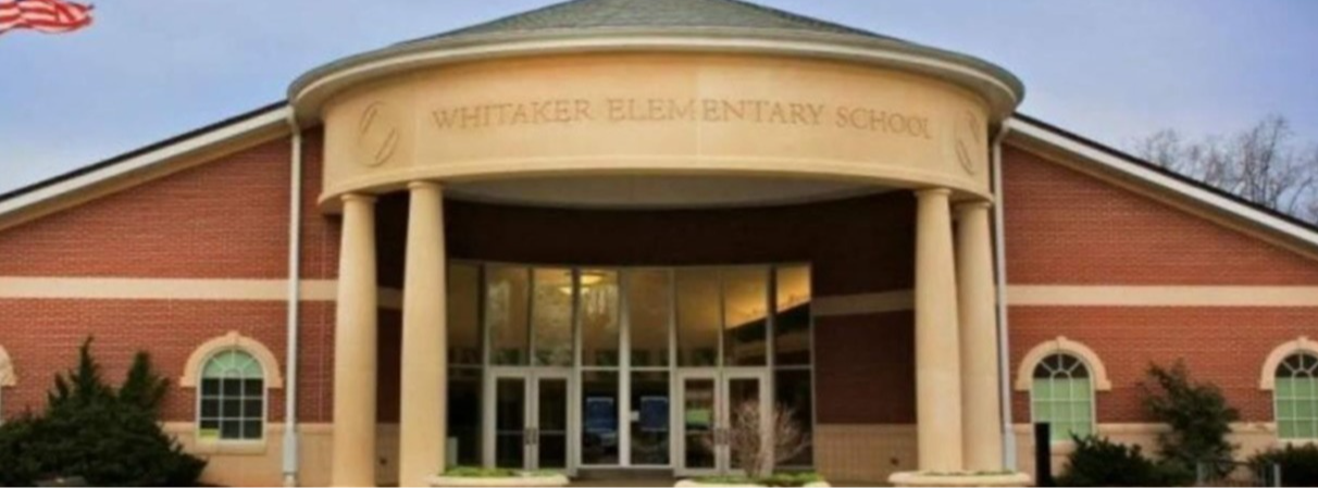 Photo of the front of the school building with rotunda