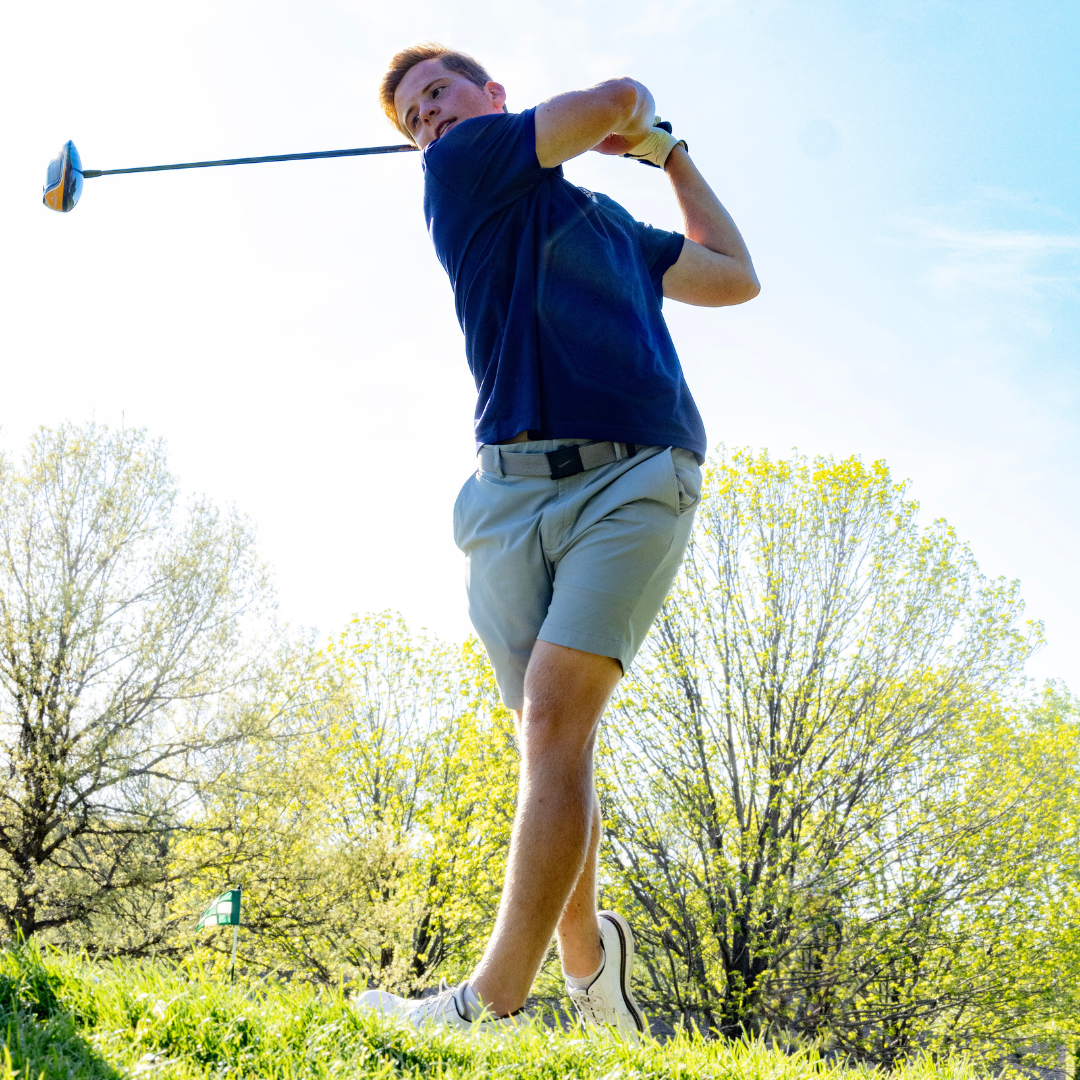 kid teeing up for golf