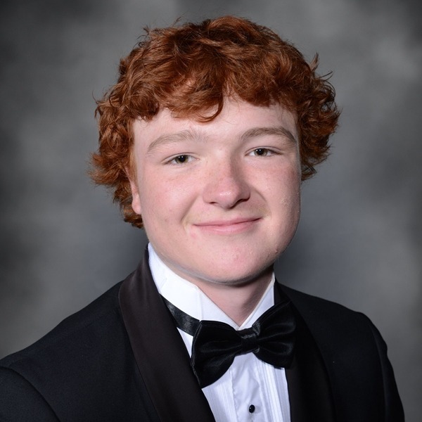 Senior Portrait of Ryan Shields. He is wearing a white shirt with a black jacket and a black bow tie. The portrait is just a headshot, form the chest up.