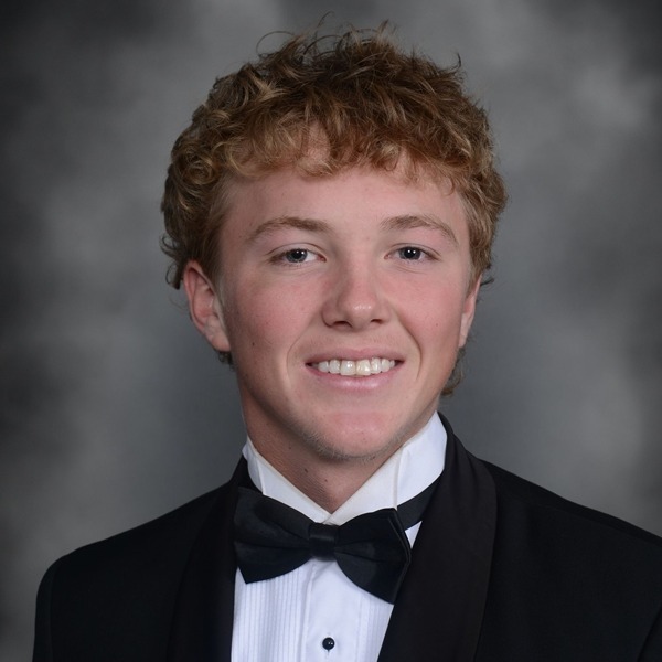 Senior Portrait of Brett Allen. He is wearing a white shirt with a black jacket and a black bow tie. The portrait is just a headshot, form the chest up.