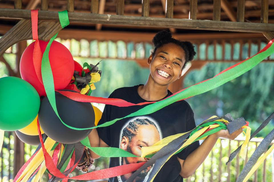 Portrait of a woman at Juneteenth with streamers