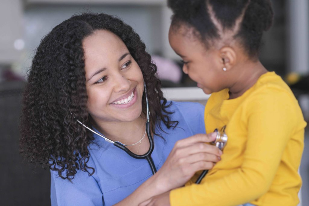 Nurse and girl in medical appointment