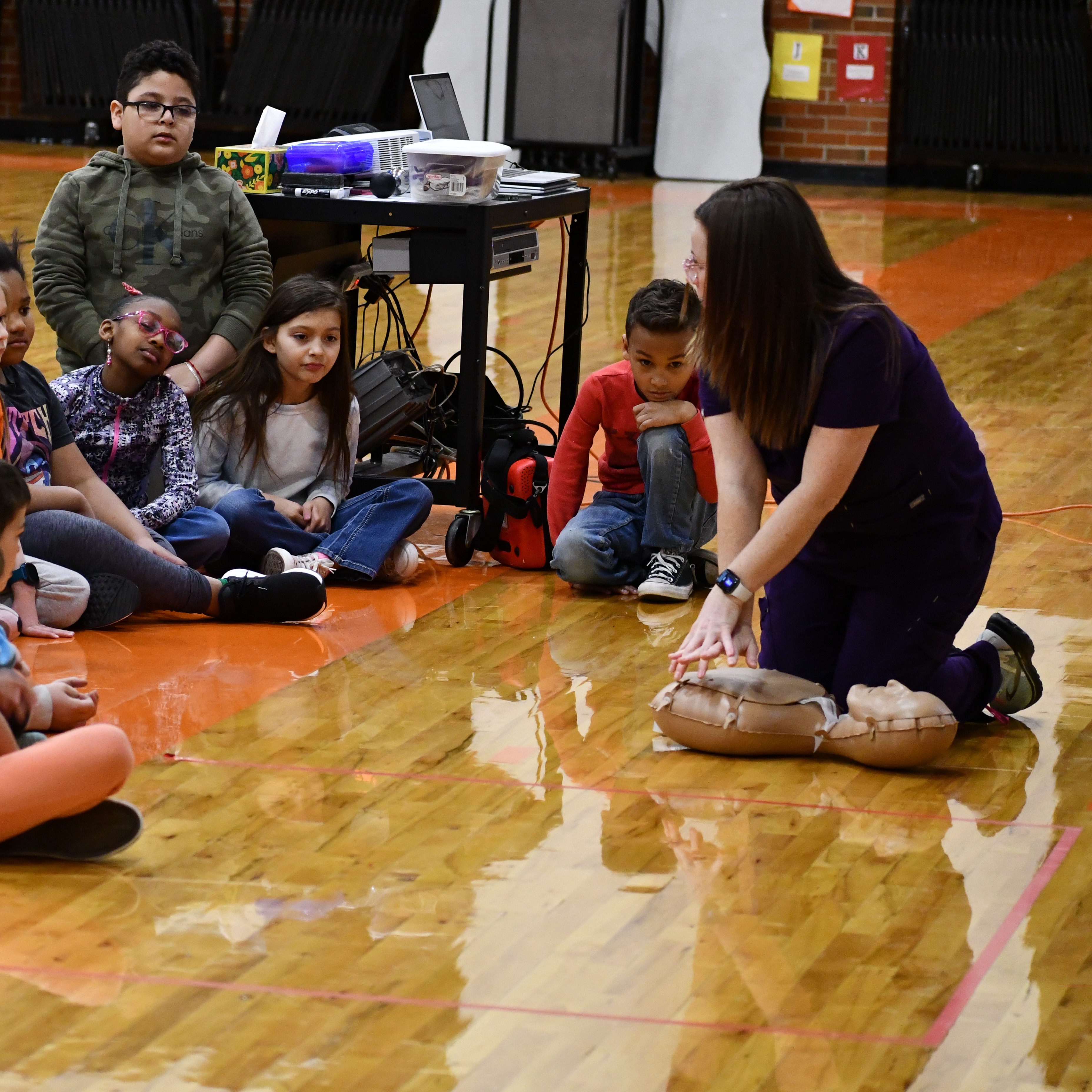 nurse teaching a group of students CPR