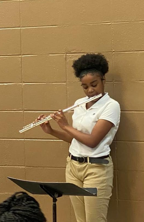 Student playing the flute. 