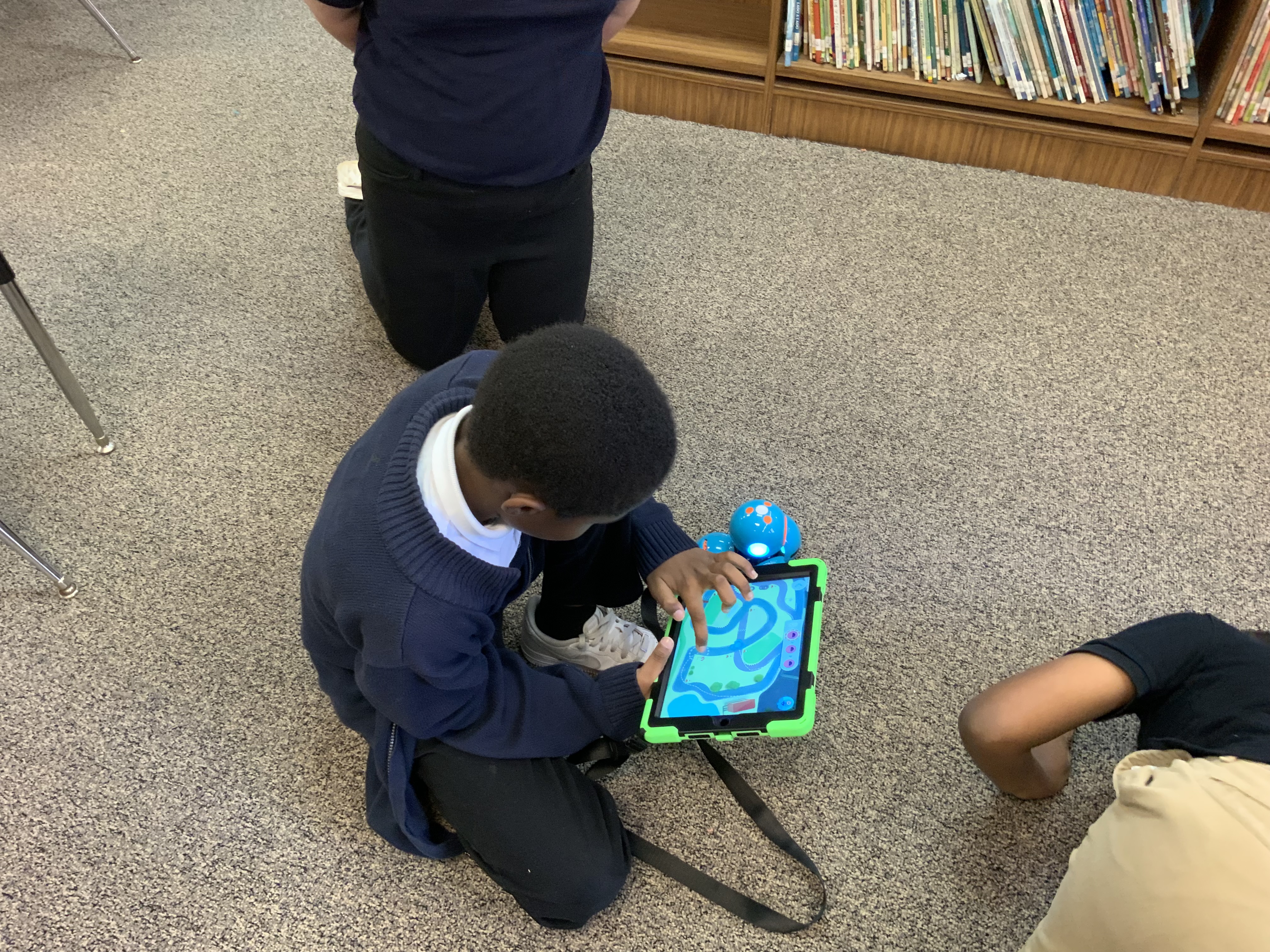 Boy driving a Wonder robot with iPad