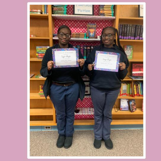 students holding award