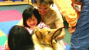 girl playing with dog