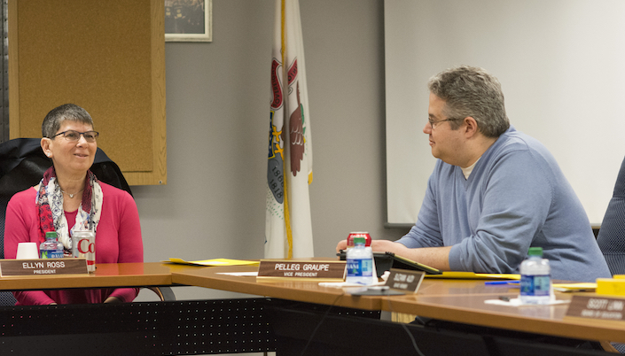 members of the board on a meeting talking to each other, seated in their respective places