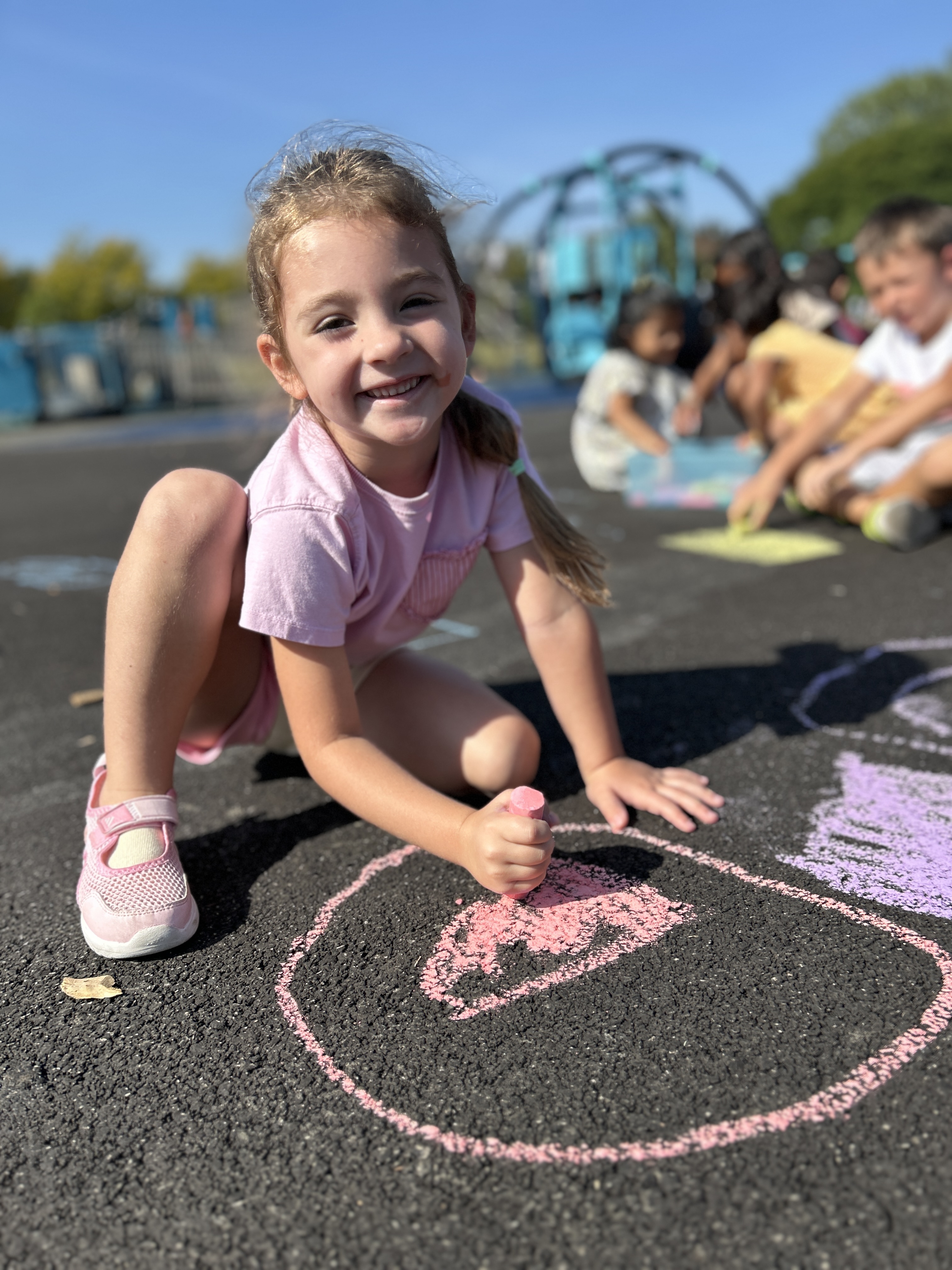 Girl with sidewalk chalk.